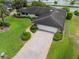 Well-maintained single story home with a tile roof, manicured landscaping, and a brick driveway at 10 Pilot Pl, Winter Haven, FL 33881