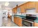 Bright kitchen with wooden cabinets, green countertops, stainless steel range, and tile flooring at 10 Pilot Pl, Winter Haven, FL 33881