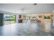 Spacious open-concept living and dining room with tiled floors and sliding doors to the outside at 10 Pilot Pl, Winter Haven, FL 33881
