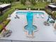 Aerial view of a unique T-shaped community pool with lounge chairs and picnic tables at 10 Pilot Pl, Winter Haven, FL 33881