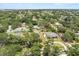 Aerial view of a neighborhood with mature trees and well-maintained homes at 12550 Lakeshore Dr, Clermont, FL 34711