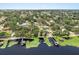 Scenic aerial view of a neighborhood with a lakefront and docks at 12550 Lakeshore Dr, Clermont, FL 34711