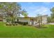Lush backyard with mature trees and landscaping, offering privacy at 12550 Lakeshore Dr, Clermont, FL 34711