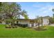 Spacious backyard featuring mature trees and manicured landscaping at 12550 Lakeshore Dr, Clermont, FL 34711