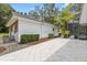 Spacious backyard with an exterior view of an outdoor patio and landscaped area at 12550 Lakeshore Dr, Clermont, FL 34711