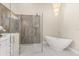 Modern bathroom featuring a soaking tub, glass enclosed shower, and soft lighting at 12550 Lakeshore Dr, Clermont, FL 34711