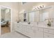 Bright bathroom featuring double vanity, marble countertops, and modern fixtures at 12550 Lakeshore Dr, Clermont, FL 34711