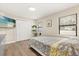 Comfortable bedroom featuring wood floors, double closet, and natural light at 12550 Lakeshore Dr, Clermont, FL 34711