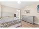 Cozy bedroom features wood floors, neutral paint, and a comfortable bed at 12550 Lakeshore Dr, Clermont, FL 34711