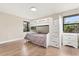 Bedroom with wood floors features a bunk bed with built in drawers at 12550 Lakeshore Dr, Clermont, FL 34711