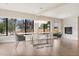 Bright dining room featuring a modern glass table, stylish chairs, and a cozy fireplace at 12550 Lakeshore Dr, Clermont, FL 34711