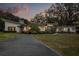 Charming exterior view of a modern home featuring well-manicured landscaping and a spacious driveway at 12550 Lakeshore Dr, Clermont, FL 34711