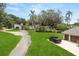 Landscaped house, a garage, and a pickup truck are visible on a large lot with mature trees at 12550 Lakeshore Dr, Clermont, FL 34711
