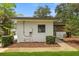 Exterior view of home displaying landscaped yard and the house's clean design at 12550 Lakeshore Dr, Clermont, FL 34711