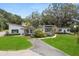 Stunning home with manicured lawn and mature trees creating curb appeal at 12550 Lakeshore Dr, Clermont, FL 34711