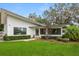 Well-maintained home with lush landscaping and inviting walkway at 12550 Lakeshore Dr, Clermont, FL 34711