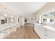 Modern kitchen with stainless appliances, marble counters, island seating and seamless access to living area at 12550 Lakeshore Dr, Clermont, FL 34711