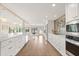 Modern kitchen with white cabinetry, stainless steel appliances, hardwood floors, and spacious countertops at 12550 Lakeshore Dr, Clermont, FL 34711