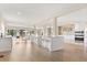 Open-concept kitchen featuring an island with barstool seating, pendant lighting, and modern appliances at 12550 Lakeshore Dr, Clermont, FL 34711