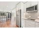 Updated kitchen with stainless steel appliances and hardwood floors at 12550 Lakeshore Dr, Clermont, FL 34711