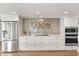 Modern kitchen featuring stainless steel appliances, sleek cabinetry, and decorative backsplash at 12550 Lakeshore Dr, Clermont, FL 34711