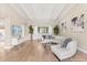 Bright living room featuring hardwood floors, tray ceilings, and stylish decor at 12550 Lakeshore Dr, Clermont, FL 34711
