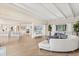 Bright living room with hardwood floors, beamed ceilings, and a large window offering natural light at 12550 Lakeshore Dr, Clermont, FL 34711