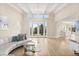 Spacious living room featuring high ceilings, hardwood floors, and large windows bringing in natural light at 12550 Lakeshore Dr, Clermont, FL 34711
