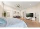 Bright main bedroom features wood floors, sitting area, and modern ceiling fan at 12550 Lakeshore Dr, Clermont, FL 34711