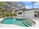 Refreshing screened-in pool with a gradual step entry for easy access at 12550 Lakeshore Dr, Clermont, FL 34711