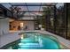 Inviting in-ground pool with a screened enclosure, and a spacious deck for lounging and entertaining at 12550 Lakeshore Dr, Clermont, FL 34711