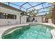 Inviting screened-in pool area with outdoor seating and a serene ambiance at 12550 Lakeshore Dr, Clermont, FL 34711