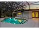 Sparkling in-ground swimming pool with a screened enclosure and patio, offering a private outdoor retreat at 12550 Lakeshore Dr, Clermont, FL 34711