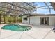 Clear screened-in pool surrounded by patio space and comfortable outdoor seating at 12550 Lakeshore Dr, Clermont, FL 34711