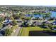 Scenic aerial view showcases a lakeside neighborhood with mature trees and well-kept homes at 12924 Lower River Blvd, Orlando, FL 32828