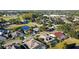 Aerial view of the community featuring mature trees, a pond, and neighborhood streets at 12924 Lower River Blvd, Orlando, FL 32828