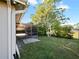 Backyard featuring a screened-in porch, green lawn, and perimeter fence at 12924 Lower River Blvd, Orlando, FL 32828