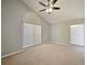 Bright bedroom with high ceilings, two large windows, and ceiling fan at 12924 Lower River Blvd, Orlando, FL 32828
