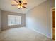 Bedroom featuring neutral walls, carpet, a ceiling fan, and a window with blinds at 12924 Lower River Blvd, Orlando, FL 32828