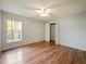 Bright bedroom features wood floors, a window, and closet at 12924 Lower River Blvd, Orlando, FL 32828