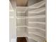 Organized closet with white shelves and grey walls, providing ample storage space at 12924 Lower River Blvd, Orlando, FL 32828