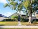 Charming single-story home with a well-manicured lawn and mature trees in a sunny neighborhood at 12924 Lower River Blvd, Orlando, FL 32828
