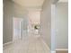 Open hallway features tile flooring leading to a bright living space with backyard views at 12924 Lower River Blvd, Orlando, FL 32828