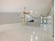Bright open-concept living room with tile flooring and view of the kitchen at 12924 Lower River Blvd, Orlando, FL 32828