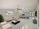 Bright open-concept living room featuring tile flooring, modern furnishings, and access to the kitchen at 12924 Lower River Blvd, Orlando, FL 32828