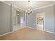 Open living room with chandelier, light walls, and views into the kitchen at 12924 Lower River Blvd, Orlando, FL 32828