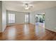 Spacious main bedroom featuring wood floors, bright windows, and a sliding glass door to the outside at 12924 Lower River Blvd, Orlando, FL 32828