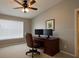 Office features a ceiling fan, desk with dual monitors, and a comfortable chair at 12924 Lower River Blvd, Orlando, FL 32828