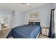 Bedroom with queen bed, dresser, and access to bathroom at 2203 San Vittorino Cir # 102, Kissimmee, FL 34741