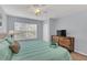 Bright bedroom with a king-size bed, dresser and large window at 2203 San Vittorino Cir # 102, Kissimmee, FL 34741